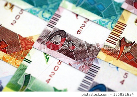 Qatari riyal money bills banknotes lies in big pile on table close up. Concept of finances and business in Qatar 135921654