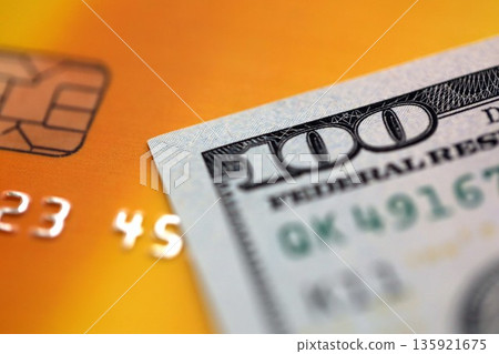 One hundred US dollar bill banknote on gold credit card for banking and payments. Concept of business and bank service 135921675