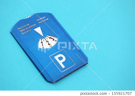 Parking disc for windshield. Limited time parking system in european countries. Concept of parking time count in busy parking lots Parking disc for windshield. Limited time parking system in european countries. Concept of parking time count in busy parking lots 135921707