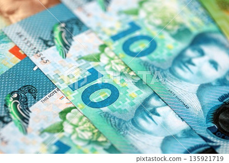 New Zealand dollar money bills in big amount on table close up. Rich life concept in New Zealand. Business and economy New Zealand dollar money bills in big amount on table close up. Rich life concept in New Zealand. Business and economy 135921719