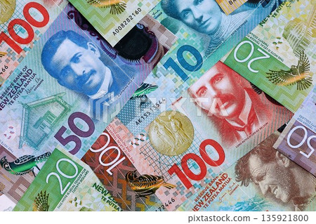 New Zealand dollar money bills in big amount on table close up. Rich life concept in New Zealand. Business and economy New Zealand dollar money bills in big amount on table close up. Rich life concept in New Zealand. Business and economy 135921800