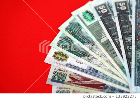 Egyptian pound money bills in big amount on red close up. Finance and banking concept Egyptian pound money bills in big amount on red close up. Finance and banking concept 135922273