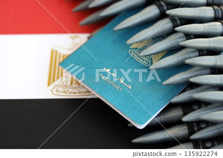 Egyptian passport and rifle bullets on flag close up. The concept of warfare and gun selling Egyptian passport and rifle bullets on flag close up. The concept of warfare and gun selling 135922274