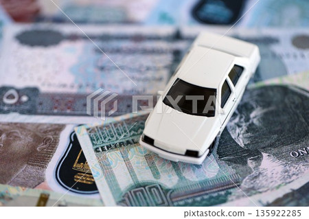 Egyptian pound currency money bills and toy car close up. The concept of car ownership Egyptian pound currency money bills and toy car close up. The concept of car ownership 135922285