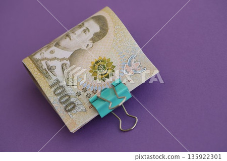 Thai baht money bills in big amount on purple close up. Finance and banking concept 135922301
