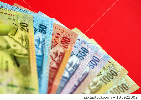 Thai baht money bills in big amount on red close up. Finance and banking concept 135922302