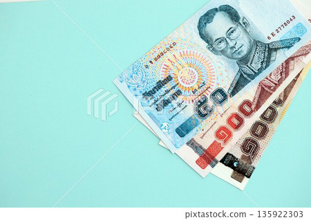 Thai baht money bills in big amount on blue close up. Finance and banking concept 135922303