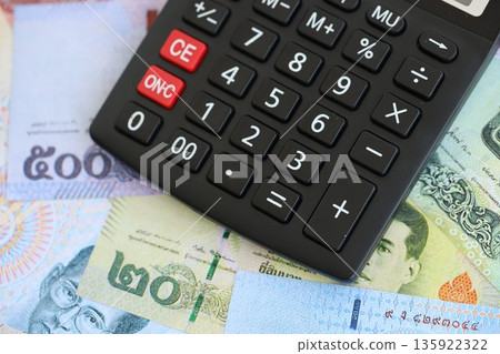 Thai baht currency money bills and calculator close up. The concept of taxation and money count 135922322