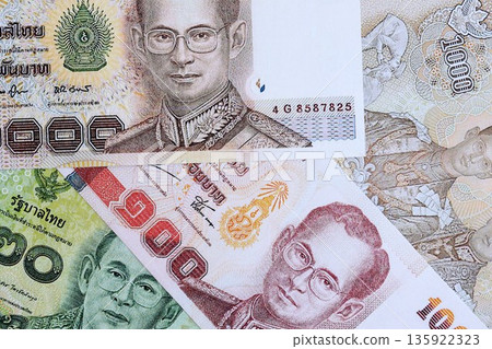 Thai baht currency money bills. The current banknotes lies on table in big amount close up 135922323