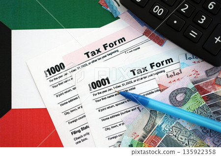 Kuwaiti dinar money bills and calculator with tax form on flag close up. Taxation and accounting concept Kuwaiti dinar money bills and calculator with tax form on flag close up. Taxation and accounting concept 135922358