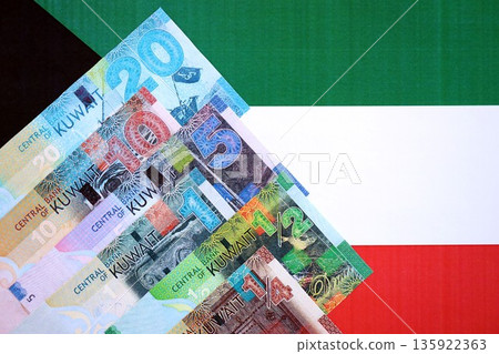 Kuwaiti dinar currency money bills lies on flag close up. The concept of business and investment Kuwaiti dinar currency money bills lies on flag close up. The concept of business and investment 135922363