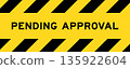 Yellow and black color with line striped label banner with word pending approval 135922604