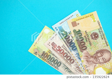 Vietnamese dong money bills in big amount close up on blue. Finance and banking concept 135922624