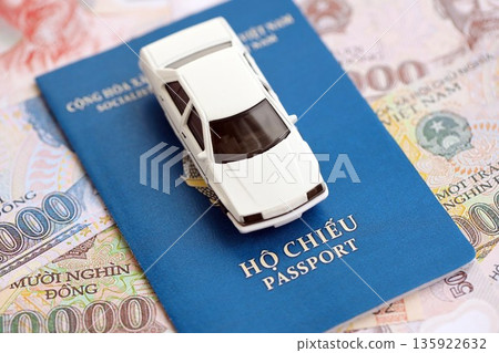 Vietnamese dong currency money bills and car with passport close up. The concept of car ownership 135922632