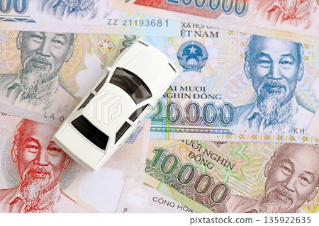 Vietnamese dong currency money bills and toy car close up. The concept of car ownership 135922635