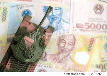 Vietnamese dong currency money bills and toy tank close up. The concept of army funds and weapons sales 135922640