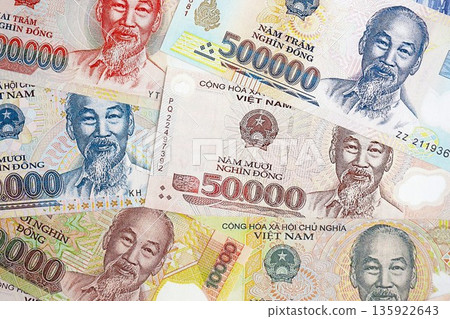 Vietnamese dong currency money bills. The current banknotes lies on table in big amount close up Vietnamese dong currency money bills. The current banknotes lies on table in big amount close up 135922643