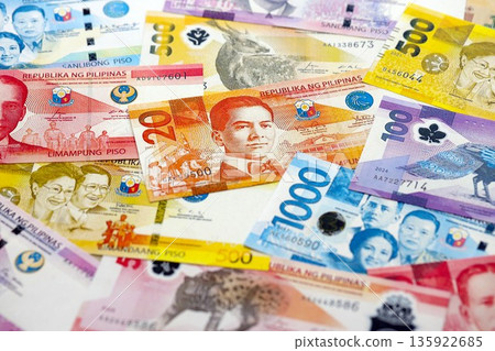 Philippines peso currency money bills. The current banknotes lies on table in big amount close up Philippines peso currency money bills. The current banknotes lies on table in big amount close up 135922685