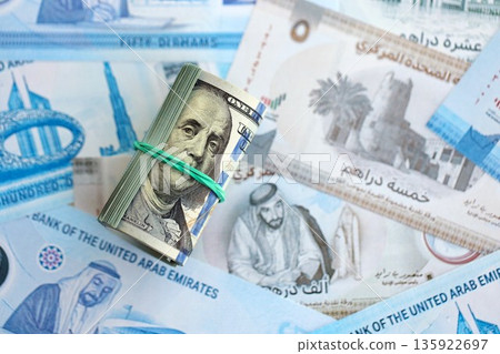 United Arab Emirates dirham currency money bills and bunch of us dollar banknotes close up. The concept of economics and currency exchange 135922697