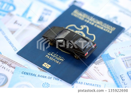 United Arab Emirates dirham currency money bills and car with passport close up. The concept of car ownership 135922698