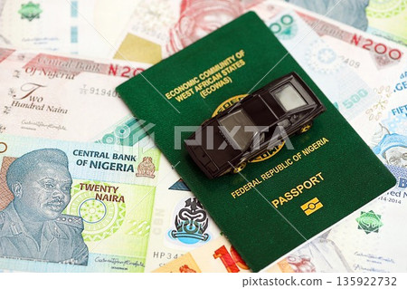Nigerian naira currency money bills and car with passport close up. The concept of car ownership Nigerian naira currency money bills and car with passport close up. The concept of car ownership 135922732