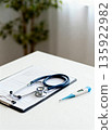 Healthcare Concept with Blue Stethoscope, Thermometer, and Medical Checklist on White Table. Professional Medical Equipment for Patient Checkup, Insurance, and Clinical Consultation. 135922982
