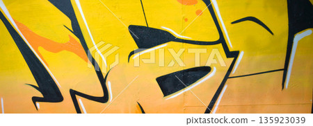 Colorful background of graffiti painting artwork with bright aerosol outlines on wall. Old school street art piece made with aerosol spray paint cans. Contemporary youth culture backdrop 135923039