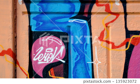Colorful background of graffiti painting artwork with bright aerosol outlines on wall. Old school street art piece made with aerosol spray paint cans. Contemporary youth culture backdrop 135923072