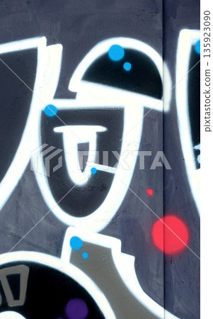 Colorful background of graffiti painting artwork with bright aerosol outlines on wall. Old school street art piece made with aerosol spray paint cans. Contemporary youth culture backdrop 135923090