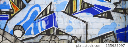 Colorful background of graffiti painting artwork with bright aerosol outlines on wall. Old school street art piece made with aerosol spray paint cans. Contemporary youth culture backdrop 135923097