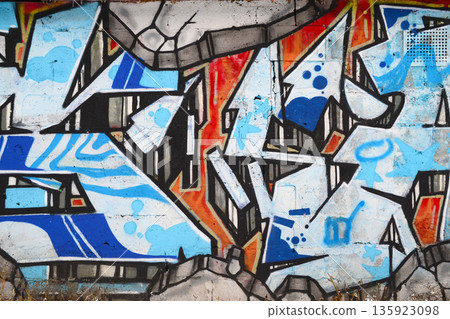 Colorful background of graffiti painting artwork with bright aerosol outlines on wall. Old school street art piece made with aerosol spray paint cans. Contemporary youth culture backdrop 135923098