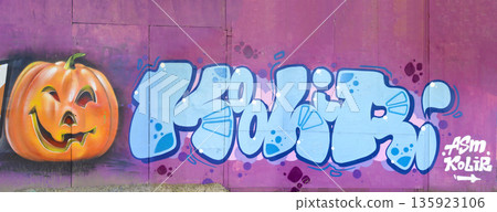The old wall decorated with paint stains in the style of street art culture. Colorful background of full graffiti painting artwork with bright aerosol outlines on wall. Colored background texture The old wall decorated with paint stains in the style of street art culture. Colorful background of full graffiti painting artwork with bright aerosol outlines on wall. Colored background texture 135923106