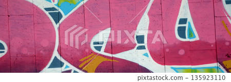Colorful background of graffiti painting artwork with bright aerosol outlines on wall. Old school street art piece made with aerosol spray paint cans. Contemporary youth culture backdrop 135923110
