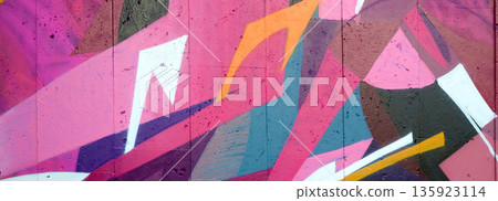 Colorful background of graffiti painting artwork with bright aerosol outlines on wall. Old school street art piece made with aerosol spray paint cans. Contemporary youth culture backdrop 135923114