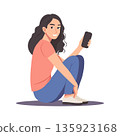 Young woman smiling and holding a smartphone while sitting on the floor. Illustration. 135923168