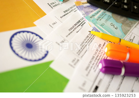 Indian income tax return blank form with pen and indian rupees bills on indian country flag close up. Annual tax report concept 135923253