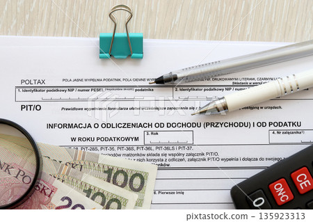 Information about deductions from income and tax, PIT-O form on accountant table with pen and polish zloty money bills close up 135923313