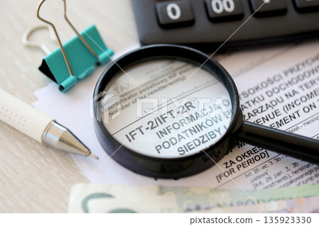 Information on revenue income derived by legal persons having no seats or place of management on territory of Poland IFT-2, IFT-2R form on accountant table with pen and polish zloty money bills Information on revenue income derived by legal persons having no seats or place of management on territory of Poland IFT-2, IFT-2R form on accountant table with pen and polish zloty money bills 135923330