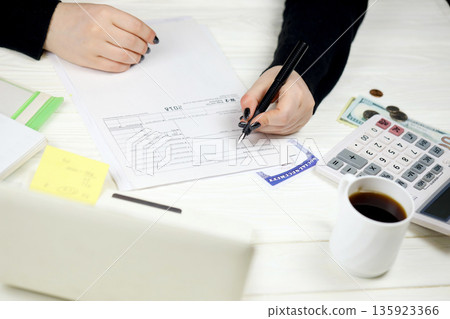 Accountant fill American tax form W-2 Wage and Tax Statement in end of tax period. Taxation and paperwork routine in United States Accountant fill American tax form W-2 Wage and Tax Statement in end of tax period. Taxation and paperwork routine in United States 135923366