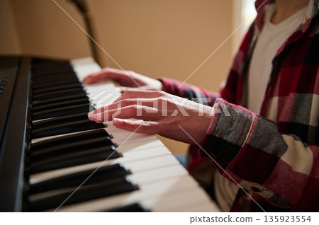 Teenage Pianist Playing Piano Hands Close Up in Casual Plaid Shirt 135923554
