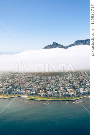 Helicopter view of Cape Town coastal city below thick cloud. South Africa mountain landscape. Stunning aerial panorama for travel tourism and postcard. 135923717