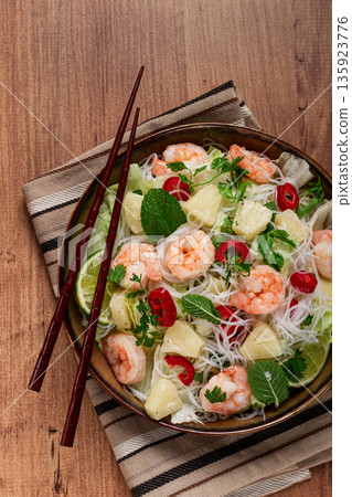 Thai salad with shrimp and rice noodles, pineapple slices, coriander and mint leaves, homemade , no people, 135923776