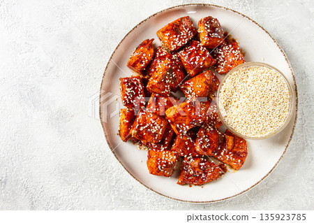 fried pieces of salmon teriyaki with sesame seeds, top view, fried pieces of salmon teriyaki with sesame seeds, top view, 135923785