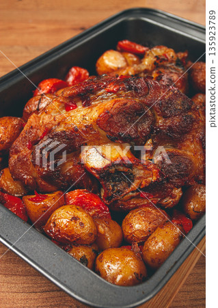 Pork knuckle, baked with vegetables, new potatoes , on a baking sheet, homemade, no people, Pork knuckle, baked with vegetables, new potatoes , on a baking sheet, homemade, no people, 135923789