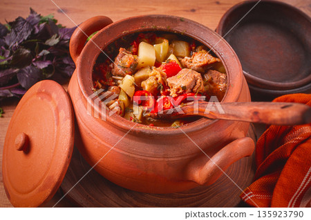 Chanakhi, a Georgian dish. in a clay pot, on a wooden table, stewed meat with vegetables, homemade, no people, Chanakhi, a Georgian dish. in a clay pot, on a wooden table, stewed meat with vegetables, homemade, no people, 135923790