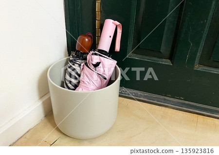 Umbrellas in a Stand by the Entryway Door 135923816