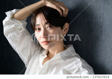 A woman with a cool expression on a black background A woman with a cool expression on a black background 135923828