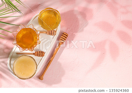 Assortment of meadow, flower, bee honey and nectar for banner at honey fair or sale,Variety of honey varieties cups on the kitchen table.natural healthy product for health and treatment, 135924360