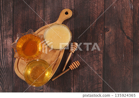 Variety of honey varieties cups on the kitchen table.Assortment of meadow, flower, bee honey and nectar for banner at honey fair or sale,natural healthy product for health and treatment, Variety of honey varieties cups on the kitchen table.Assortment of meadow, flower, bee honey and nectar for banner at honey fair or sale,natural healthy product for health and treatment, 135924365