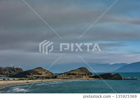 An evening view of the coastline of Vlora, Albania, taken in August 2025. Soft sunlight illuminates the rocky hills and seascape. An evening view of the coastline of Vlora, Albania, taken in August 2025. Soft sunlight illuminates the rocky hills and seascape. 135925369